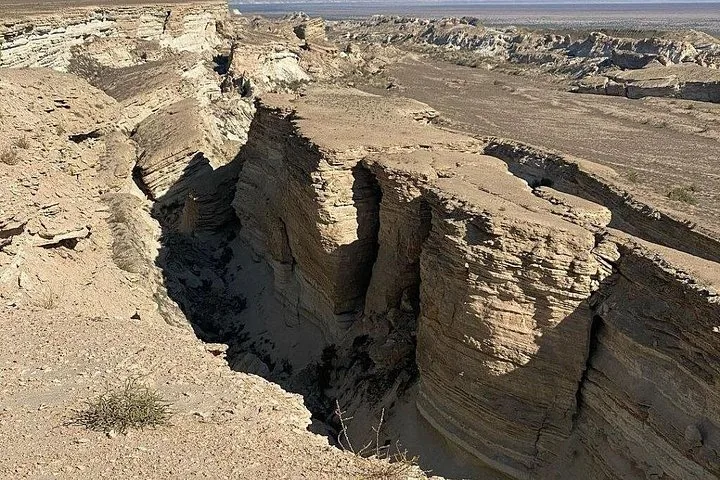View of a deep canyon with layered rock formations in a desert